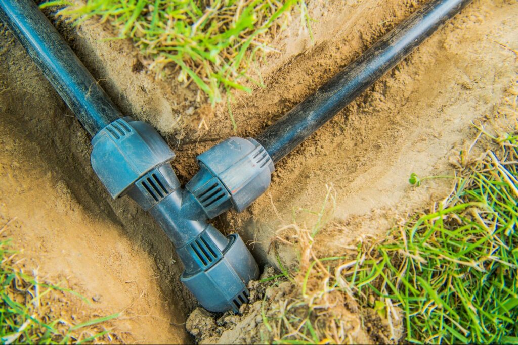 Ondergrondse leidingen in een sleuf voor de aanleg van water- en rioleringssystemen tijdens de ruwbouw.